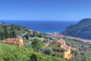 a town on a hill next to the ocean at La Locanda di Cucco in Finale Ligure