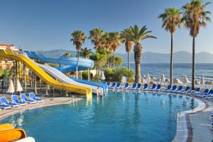 a swimming pool with a slide at a resort at Ephesia Holiday Beach Club in Kuşadası