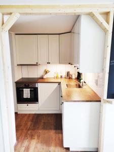 a kitchen with white cabinets and a sink at Fjellhagen in Bjørkheim