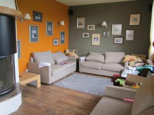 a living room with two couches and a wall with pictures at Villa Aya in Smochevo