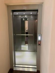 a elevator in a building with a glass door at B & B Sul Lago in Porlezza