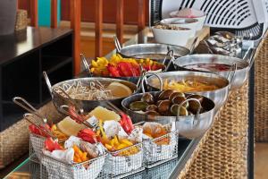 a kitchen counter filled with lots of different types of food at Orchid Eilat Hotel in Eilat