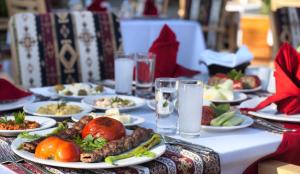 a long table with plates of food on it at Ephesia Holiday Beach Club in Kuşadası