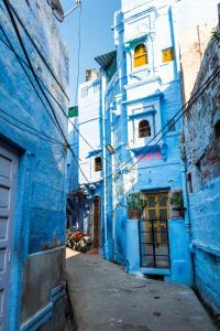 een steegje met blauwe muren en een gebouw bij Tanu's homestay in Jodhpur