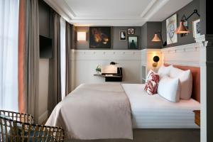 a bedroom with a bed and a window at Royal Madeleine Hotel & Spa in Paris