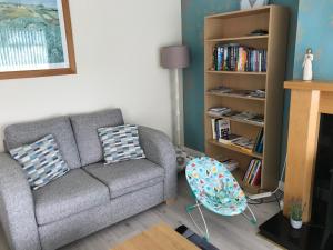 a living room with a couch and a book shelf at Suntana at Causeway Coast and Glens in Coleraine