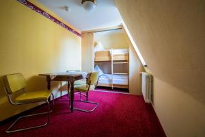 Postel nebo postele na pokoji v ubytování Hotel Löwen-Weinstube