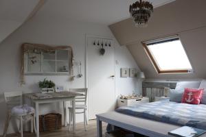 a bedroom with a bed and a table and a desk at Beachhouse Engelbert Studios in Zandvoort