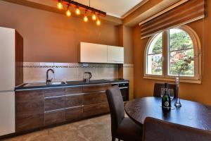 a kitchen with a table and a sink at Regina del Mare in Bar