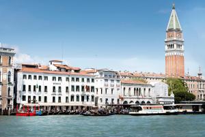 a large building with a clock tower on top of it at Monaco & Grand Canal in Venice