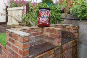 a bag of mulch sitting on top of a brick wall at City Retreat, Spacious 4 Bed House, Games Room, Parking, Hot Tub & BBQ in Cardiff