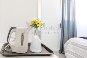 a mixer and a vase with flowers on a tray at AYZ Sierra de Meira - Auto check-in property in Madrid