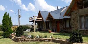 a house with a porch and a staircase on it at MacFarlanes in Harrismith