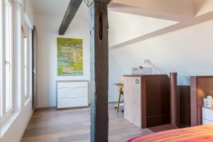 a bedroom with a bed and a desk in a room at LOFT AU COEUR DE LA VALLÉE DE LA LOIRE in Montlouis-sur-Loire