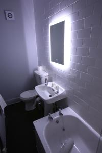 a bathroom with a sink and a tub and a toilet at The Queens Head Hotel in Rothbury