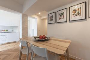 a dining room with a wooden table and chairs at La Bricola Terrace Apartment in Venice