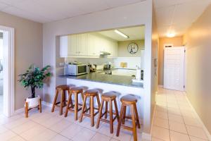 a kitchen with bar stools and a counter top at 11 Waterfront Umdloti in Umdloti
