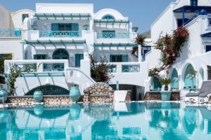 a hotel with a swimming pool in front of a building at Anastasia Princess Luxury Residence - Adults Only in Perissa