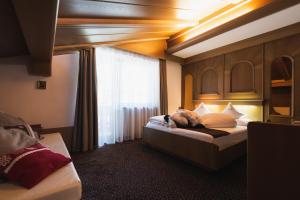 Postel nebo postele na pokoji v ubytování Hotel Catinaccio