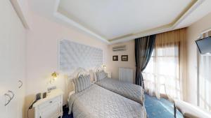 Rúm í herbergi á Hotel Mirto