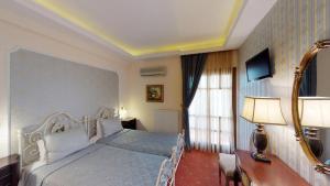 Rúm í herbergi á Hotel Mirto