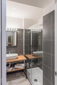 a bathroom with two sinks and a mirror at APARTHOTEL CASA MIA in Milan