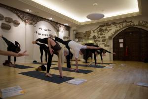 a group of people doing yoga in a room at Mai Ram Yoga House in Vilnius