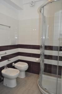 a bathroom with a toilet and a shower at Hotel Sikania in San Vito lo Capo