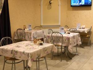 a group of tables with white table cloths on them at Gonchar Hotel in Kyiv