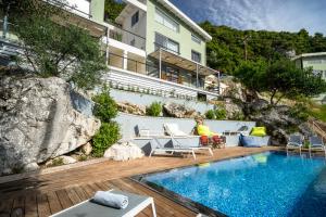 a hotel with a swimming pool next to a building at Soul Beach Suites in Vasiliki