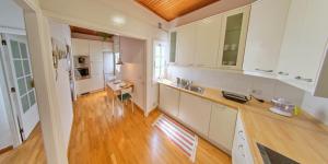 una cucina con armadietti bianchi e pavimenti in legno di NEBRIJA a Santa Cruz de Tenerife