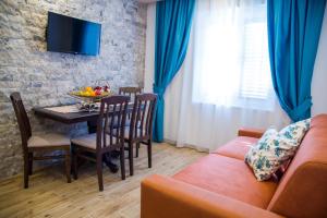 a living room with a couch and a table at Guest House S-Lux in Petrovac na Moru