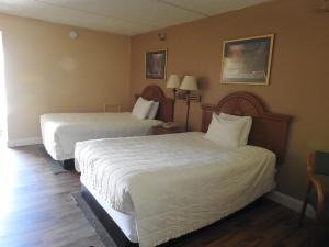 A bed or beds in a room at Relax Inn