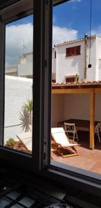 a view from a window of a balcony with a table and chairs at Casa Isabella in Calasetta