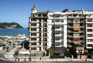 a tall white building with a lighthouse on top of it at Hotel Niza in Donostia-San Sebastián