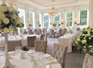 a large dining room with white tables and chairs at Rushton Hall Hotel and Spa in Kettering +82 photos