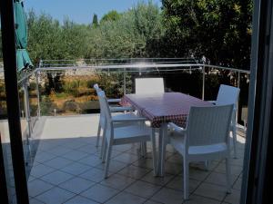 a table and chairs sitting on a patio at Apartman Nikodem in Novalja