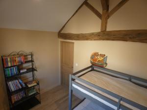 a bedroom with a bunk bed and a book shelf at Le Clos De Quintaine Gîtes de Charme in Clessé
