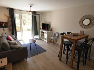a living room with a couch and a table at Le Clos De Quintaine Gîtes de Charme in Clessé