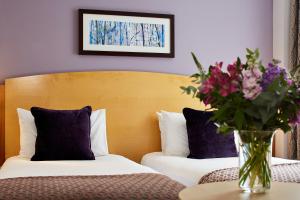 A bed or beds in a room at The Abbey 