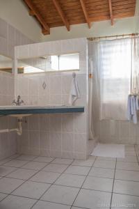 a bathroom with a shower and a sink at Sunset Bay Club & SeaSide Dive Resort in Salisbury