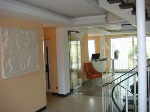 a lobby with a staircase and a chair in a building at Lindemann Hotel in Hildesheim