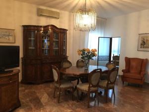 a dining room with a table and chairs and a chandelier at Casa Mamma Mia in Fiesso dʼArtico