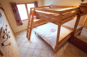 a bunk bed in a room with a ladder at Chalet la Lauzette in Bessans