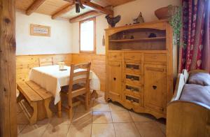 ein Esszimmer mit einem Tisch und einem Holzschrank in der Unterkunft Chalet la Lauzette in Bessans