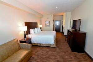 a hotel room with two beds and a television at Cobblestone Inn & Suites - Holstein in Holstein