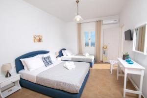 Postel nebo postele na pokoji v ubytování Caldera Sunset Villa