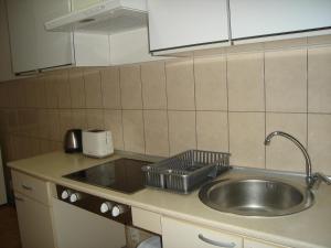 a kitchen sink with a strainer on top of it at Home Away From Home in Skopje