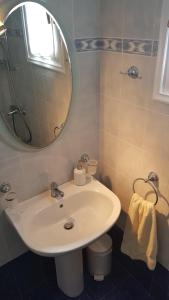 a bathroom with a white sink and a mirror at Naxos Beachvilla in Plaka +115 photos