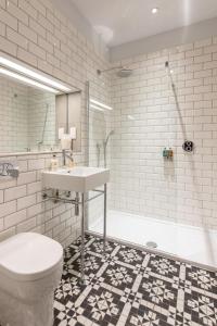 a bathroom with a sink and a toilet and a tub at Linton Collection - Blackfriars Lofts in Edinburgh +71 photos